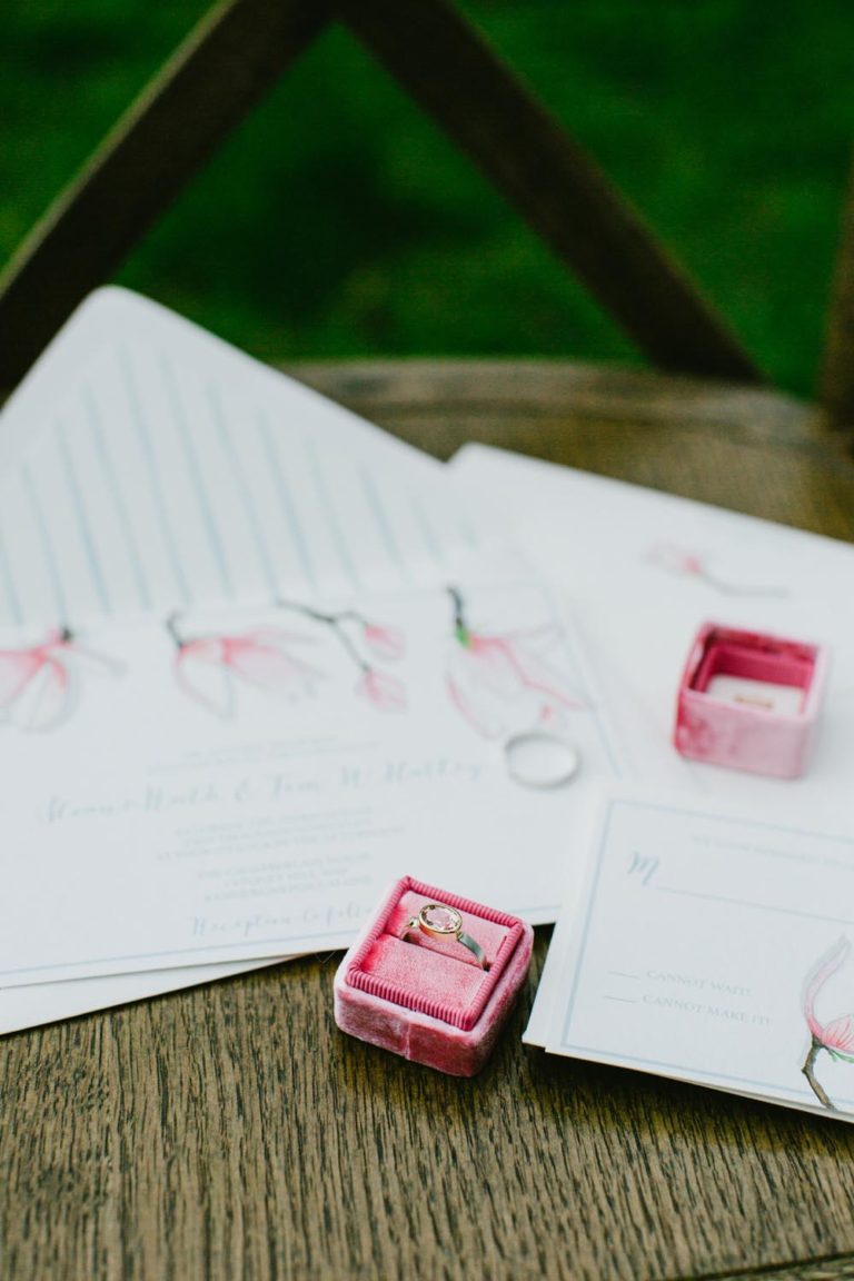 Close-up of red ink stamps and stamped papers on a wooden surface.