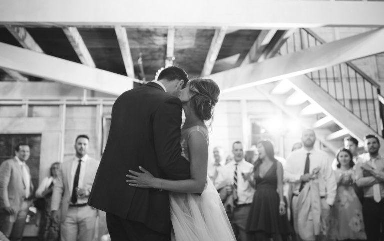 A couple shares a tender dance at their wedding reception.